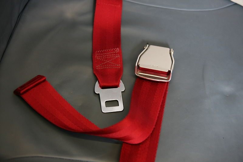 Why are the seat belts on airplanes different than the ones on cars?
