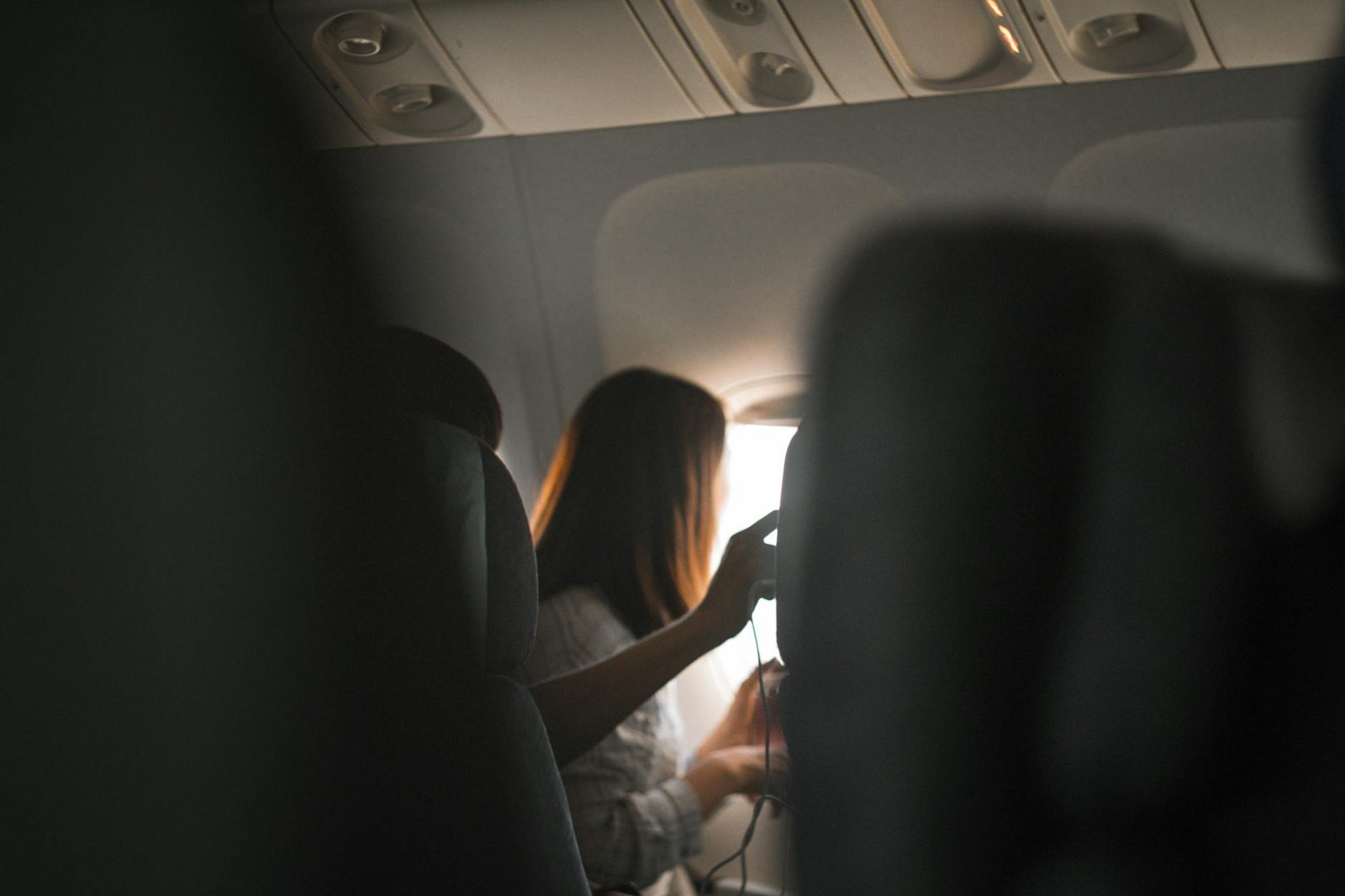 woman riding in airplane near window
