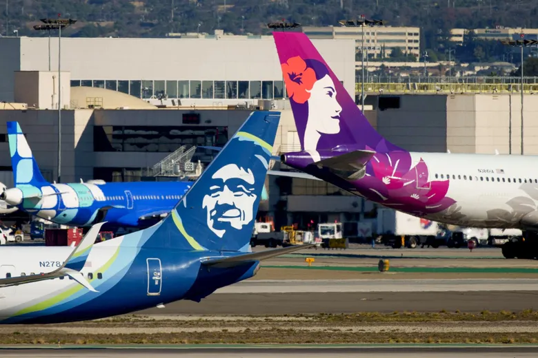 An Alaska Airlines airplane and a Hawaiian Airlines airplane at Los Angeles International Airport on Dec. 5
(Eric Thayer / Bloomberg)