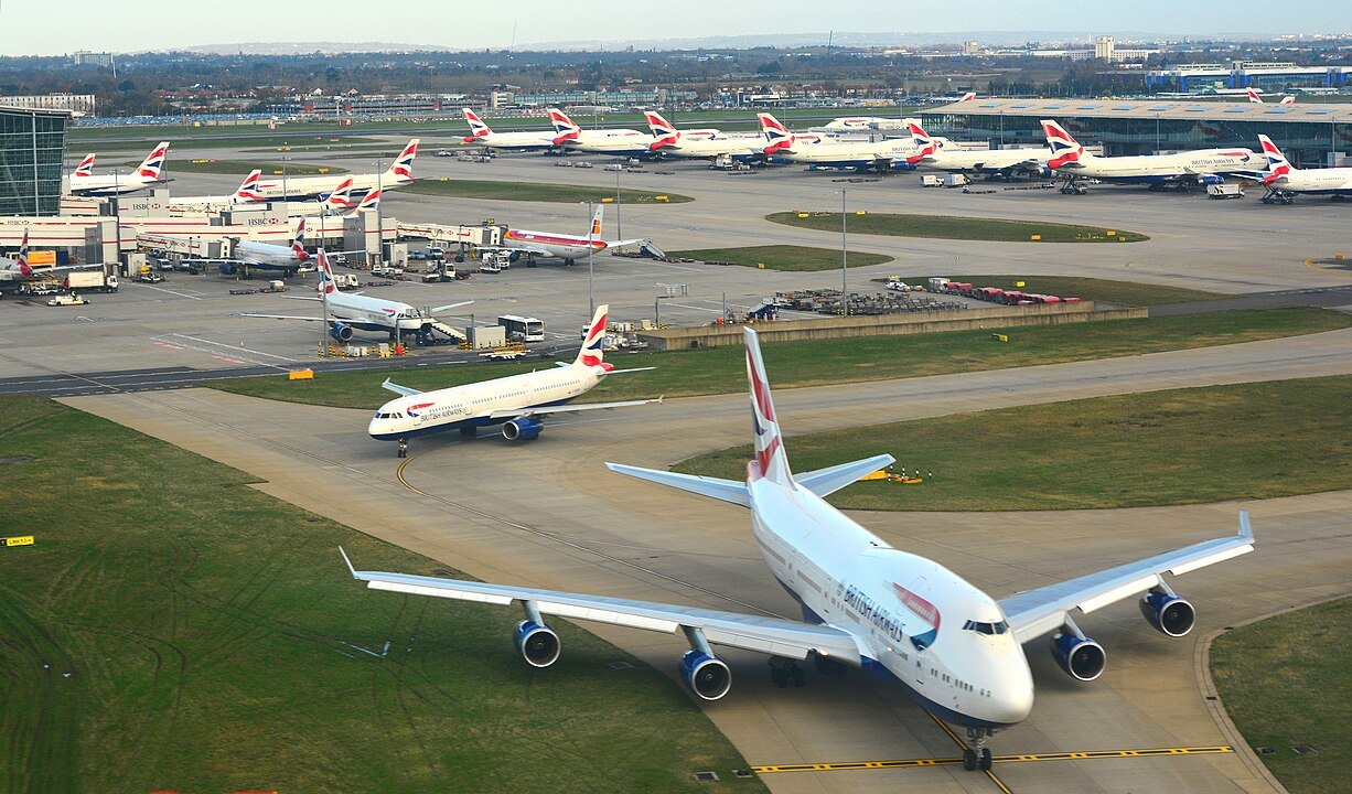 View of multiple British Airways aircraft at Heathrow Airport's Runway.